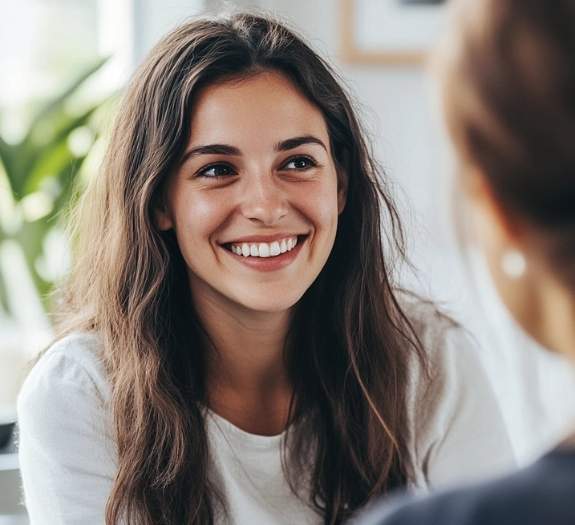 Woman smiling after ketamine treatment A woman smiling and talking to therapist after getting ketamine therapy in newport beach, ca, at oc ketamine therapy.